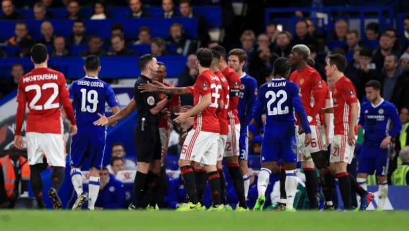 PLayers surround referee