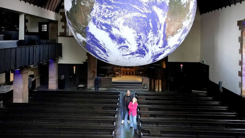 A visitor’s view of Gaia, a seven-metre-wide replica of Earth created by Luke Jerram.