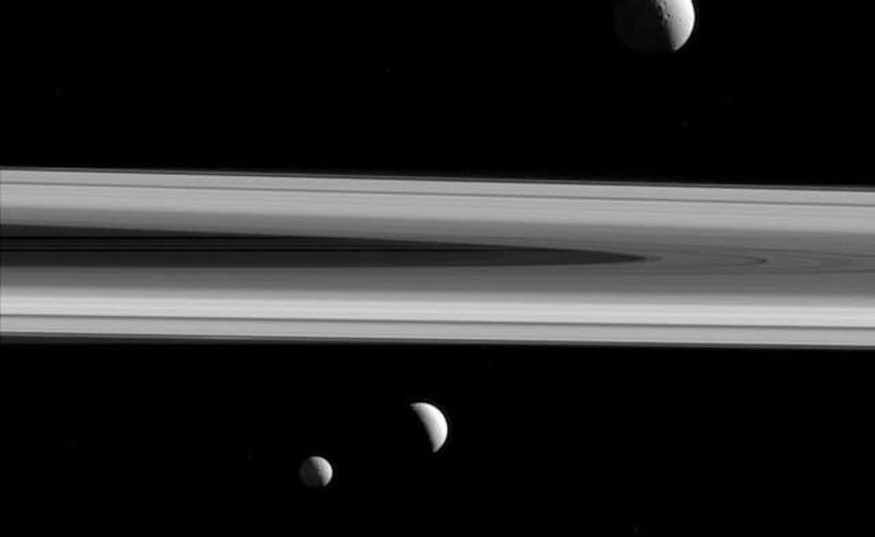 Three of Saturn's moons - Tethys, above, Enceladus, second left, and Mimas, seen from the Cassini spacecraft