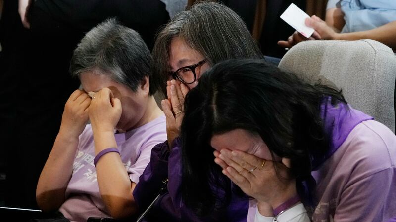 Bereaved family members of the victims of the Halloween crush in 2022 react at the National Assembly in Seoul (AP)