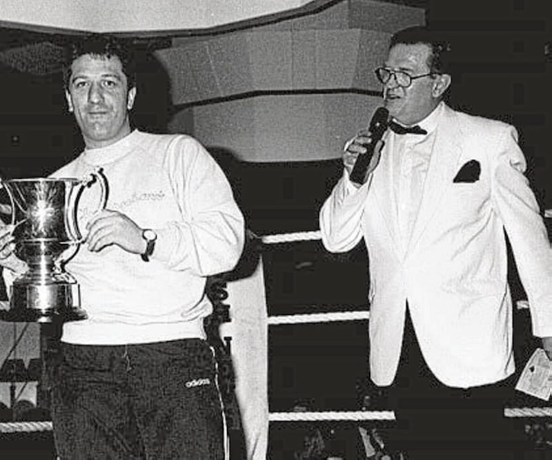 Belfast team manager Peter Watt receives the Irish News Cup as the Big Bopper, MC Harry McGavock, announces the match result.&nbsp;<span style="color: rgb(51, 51, 51); font-family: sans-serif, Arial, Verdana, &quot;Trebuchet MS&quot;; ">The cup will remain in Belfast for another year at least after a seven-strong team of brawny young home city boxers defeated mighty Dublin &ndash; and Romania &ndash; at the weekend.</span>