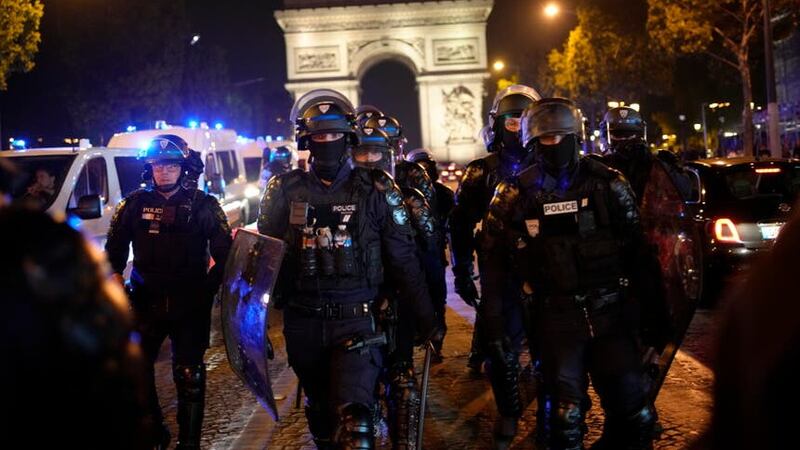 Police officers patrol in front of the Arc de Triomphe on the Champs Elysees on Saturday evening (AP Photo/Christophe Ena)