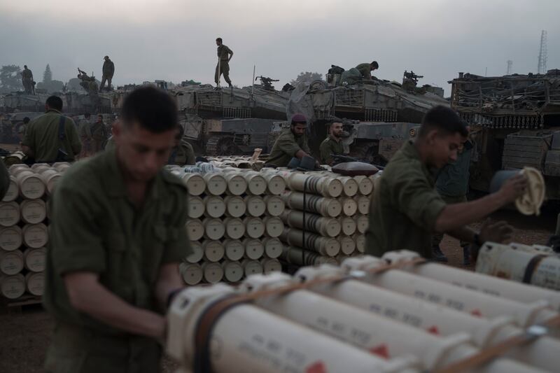 Israeli soldiers from the artillery unit store tank shells in a staging area at the Israeli-Gaza border (Leo Correa/AP)