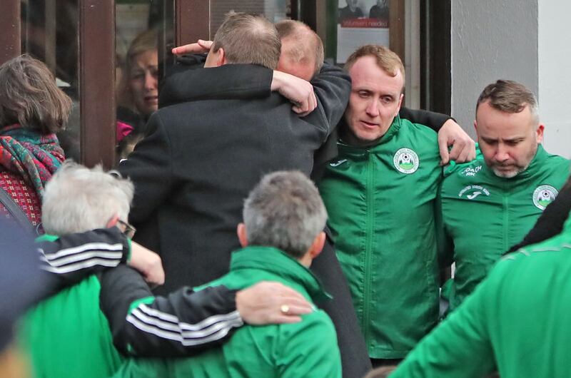 Andrew McGinley (centre back towards camera) is hugged during the funeral service for his three children Conor, Darragh and Carla who were found dead in their home at Parson's Court in Newcastle, in the south-west of Dublin city on Friday, at the Church of the Holy Family in Rathcoole, Dublin. Picture by Niall Carson/PA Wire&nbsp;
