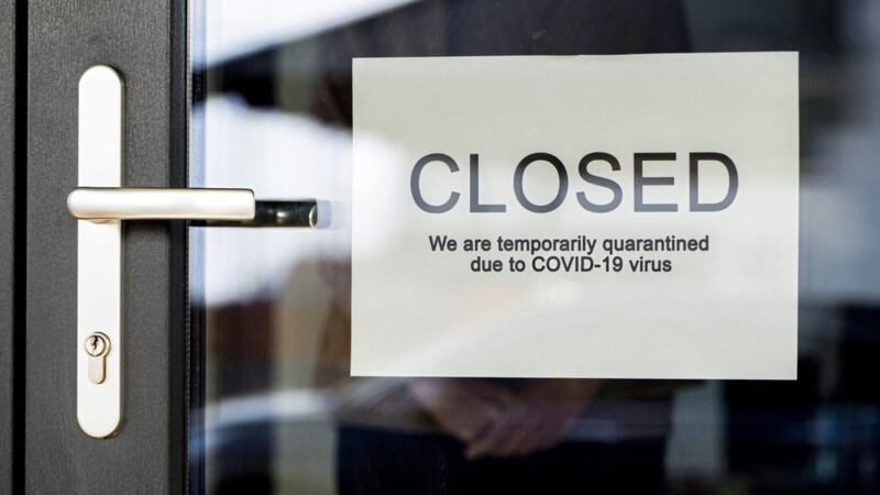 Business owner hangs on door announcement of closure due to coronavirus quarantine 