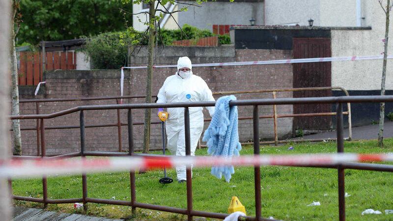 A forensic officer checking the scene at Carlisle Square, New Lodge, where a 17-year-old boy was shot in the leg. Picture by Cliff Donaldson 