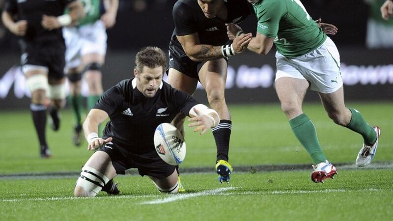 New Zealand's Richie McCaw dives for a loose ball before Ireland's Fergus McFadden (right) during the third Test match at Waikato Stadium in Hamilton, New Zealand on Saturday June 23 2012.