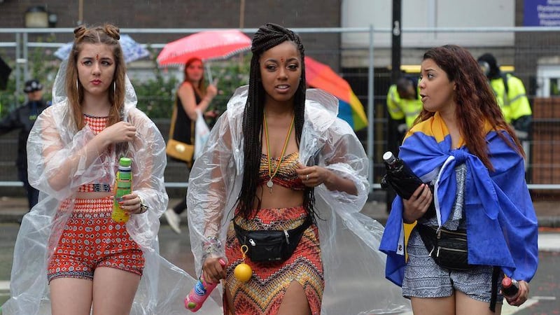 Crowds brave the rain as the watch the Bank Holiday Monday parade at the Notting Hill Carnival 2015 parade, in west London. Picture John Stillwell/PA Wire 