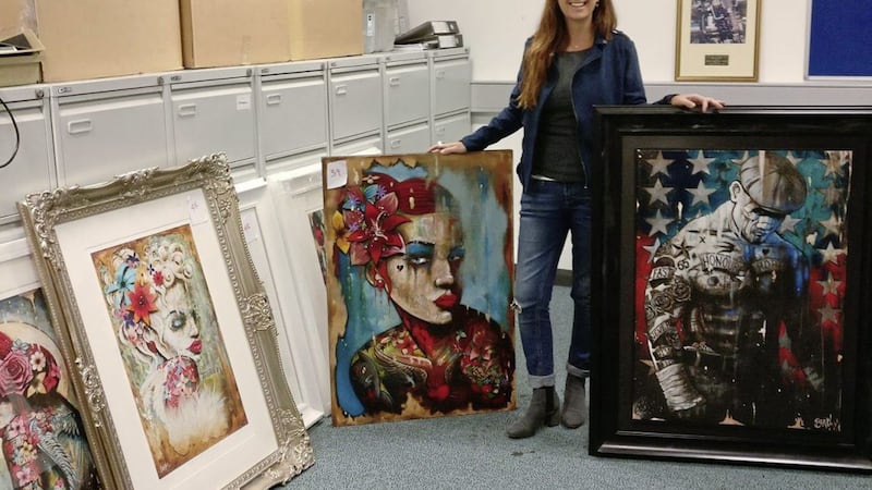 Ashley Bradley pictured with some of the pieces of art recovered during a police raid in west Belfast. Picture by Terry Bradley Art 