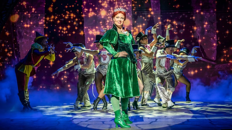 Joanne Clifton standing in front of the cast of Shrek The Musical