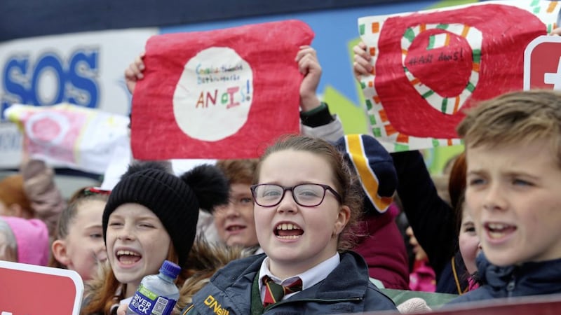 Pupils from Bunscoil Phobail Feirste protest outside the Andersonstown Leisure Centre site calling for bilingual signage in the centre when it opens next year Picture Mal McCann. 