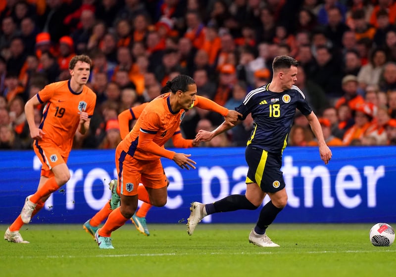 Scotland’s Lawrence Shankland and the Netherlands’ Virgil van Dijk battle for the ball