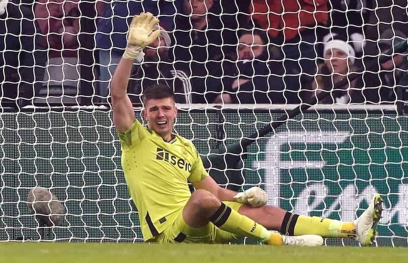 Newcastle keeper Nick Pope signals to the bench after injuring his shoulder