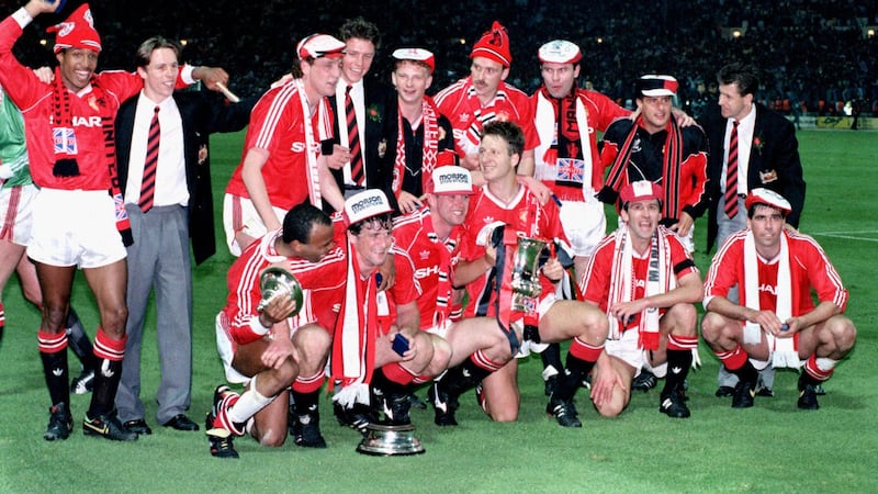 Mark Robins (middle, back row) celebrates winning the FA Cup in 1990 .
