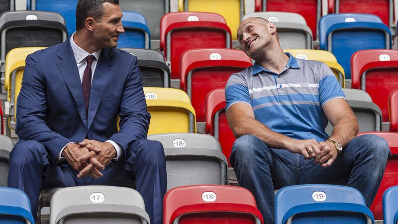 WBO, WBA, IBF and IBO heavyweight champion Wladimir Klitschko from Ukraine, left, and his challenger, Britain&#39;s Tyson Fury, sit in the Esprit Arena  ahead of their title fight in in Duesseldorf on October 24 