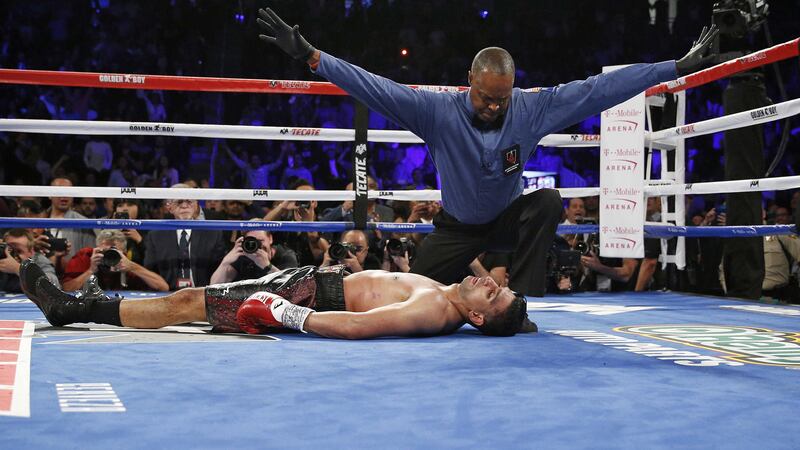 Referee Kenny Bayless calls it a day as Amir Khan lies on the canvass after being knocked out by&nbsp;Canelo Alvarez during their WBC middleweight title fight in Las Vegas on Saturday night<br />Picture by AP&nbsp;