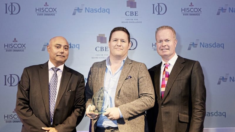 Gareth Loye, director of M&amp;M Contractors and Mascott Construction receiving his award from Karan Bawa, operations director, IoD, left, and Joe Lynam, BBC broadcaster 