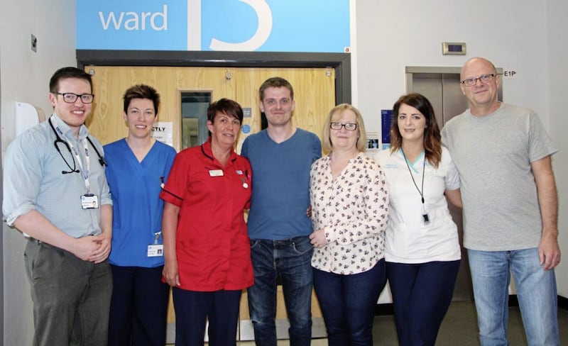Surfer Matthew Bryce (centre) with (left to right) consultant Dr Padraig Headley, nurse Rachel Sloan, ward sister Rhonda Marks, Mr Bryce&#39;s mother Isabella, physiotherapist Nicola McKenna and his father John. Picture from South Eastern Health &amp; Social Care Trust 