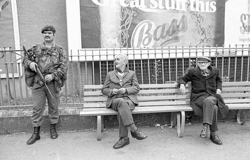 Two men on a bench and a Marine Commando pictured by S&eacute;an Hillen at Sugar Island in the centre of Newry on a Twelfth of July 