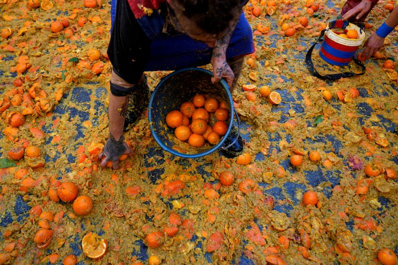 People pelt each other with oranges (Antonio Calanni/AP)