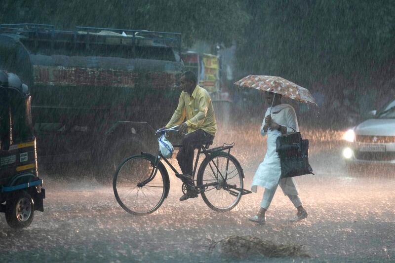 A woman walks in the rain in Jammu, India 