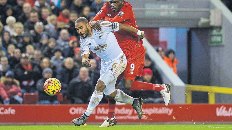 Swansea Ashley Williams tries to hold off Liverpool&rsquo;s Christian Benteke during Sunday's Premier League clash at Anfield