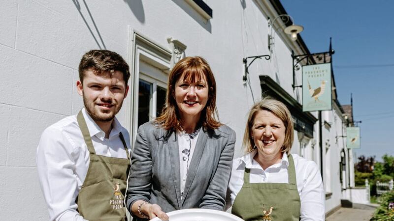 Outside the new-look Poacher&rsquo;s Pocket is joint owner and Balloo Inns Group managing director Jennie Sweeney with employees Reece Hands and Paula Boyce 