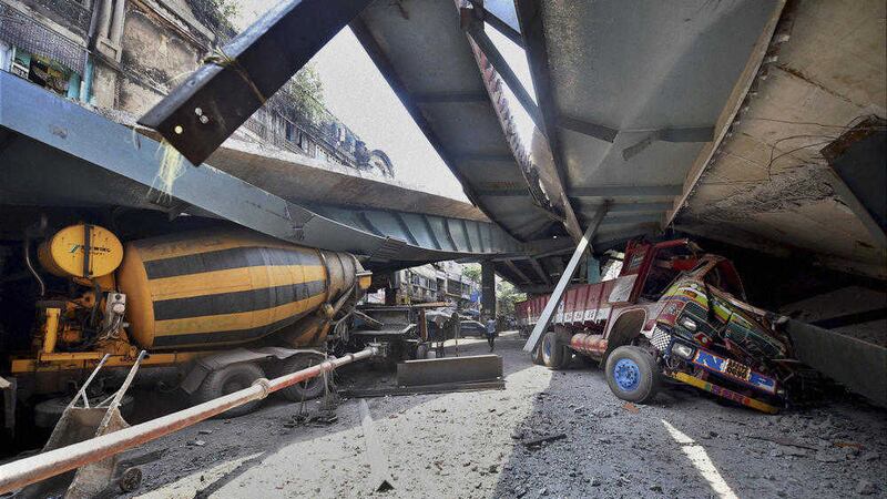 Vehicles are seen trapped under a partially collapsed overpass in Kolkata, India. Picture by Swapan Mahapatra, Press Trust of India/Associated Press