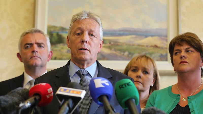 Peter Robinson watched by Jonathan Bell, Michelle McIlveen and Arlene Foster, announces he is standing aside &nbsp;