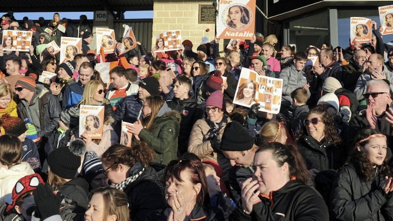 SOLIDARITY: Fans applaud and hold pictures of murder victim Natalie McNally in a tribute to the 32-year-old during the 32nd minute of yesterday&rsquo;s Allianz Football League match between Armagh and Mayo at the Box-It Athletic Grounds               PICTURE: John Merry 