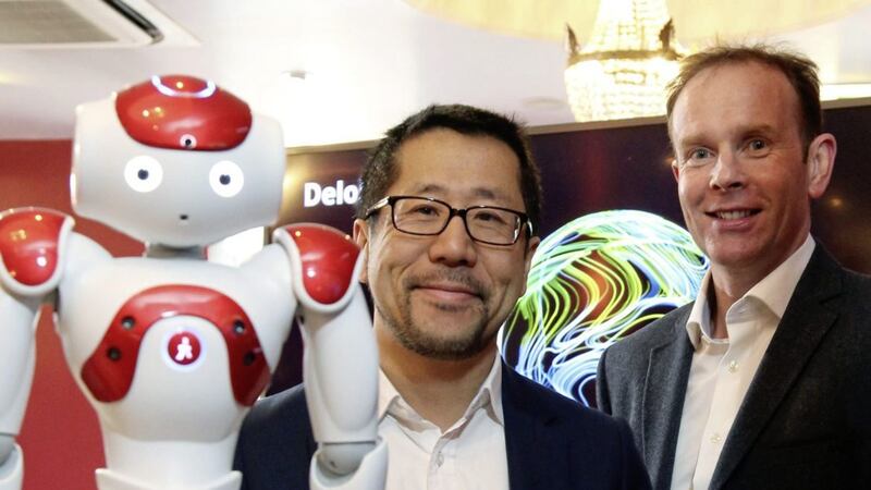 Paul Lee, TMT partner at Deloitte pictured with Danny McConnell, Deloitte&rsquo;s technology partner in Belfast, and Brittany the robot, an example of the next generation of connected artificial intelligence devices 