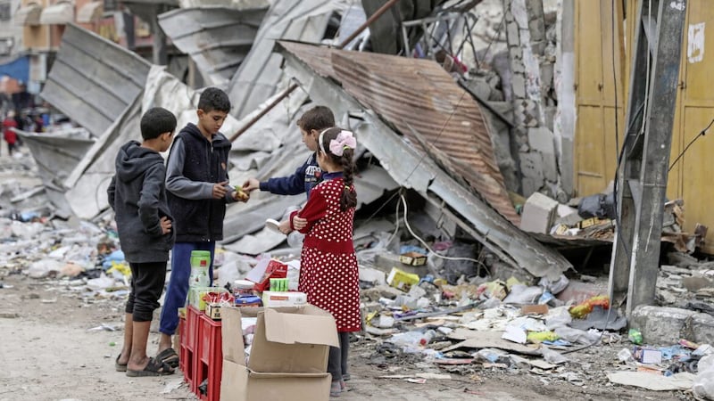 Palestinian children sell sweets in front of the rubble of a destroyed building in Jebaliya refugee camp in Gaza last week. Our world today often seems hell-bent on destruction; Advent is a reminder of the hope that leads to Christmas. PICUTRE: AP PHOTO/MOHAMMED HAJJAR 
