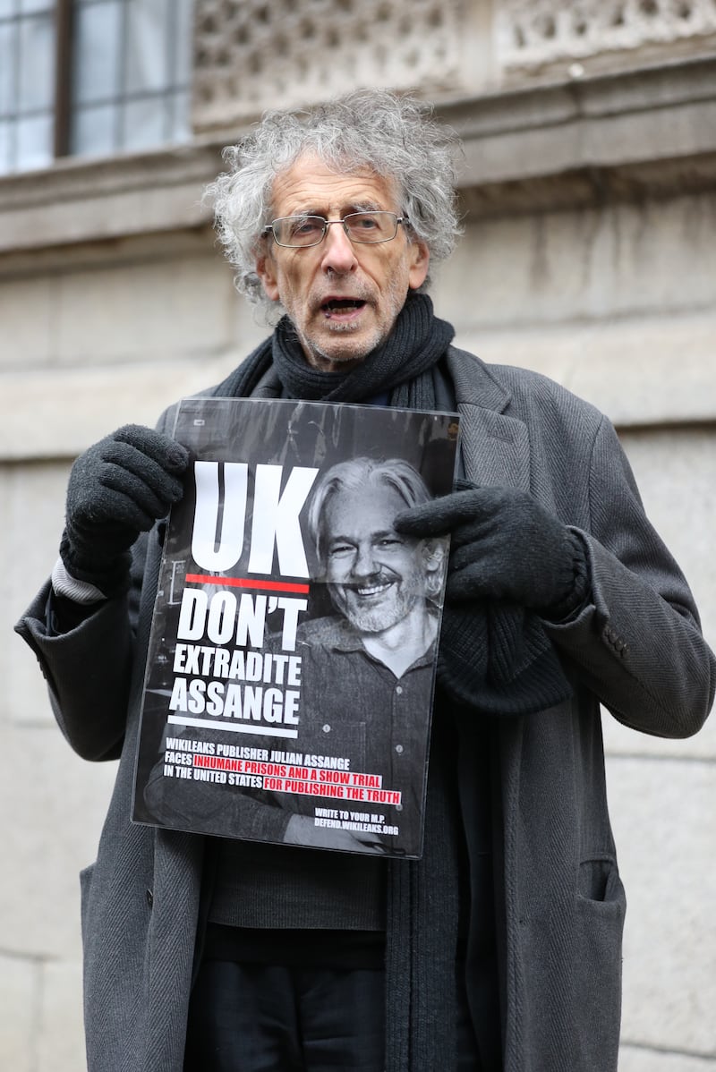 Piers Corbyn holds up a poster in support of Julian Assange outside the Old Bailey, London