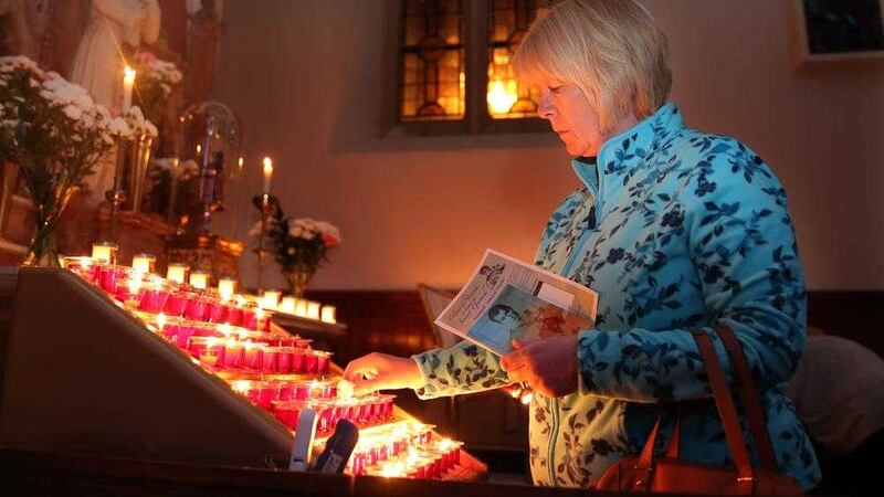 Rosaleen Agnew lights a candle at the Shrine to St Gerard at Clonard. Photograph by Declan Roughan 
