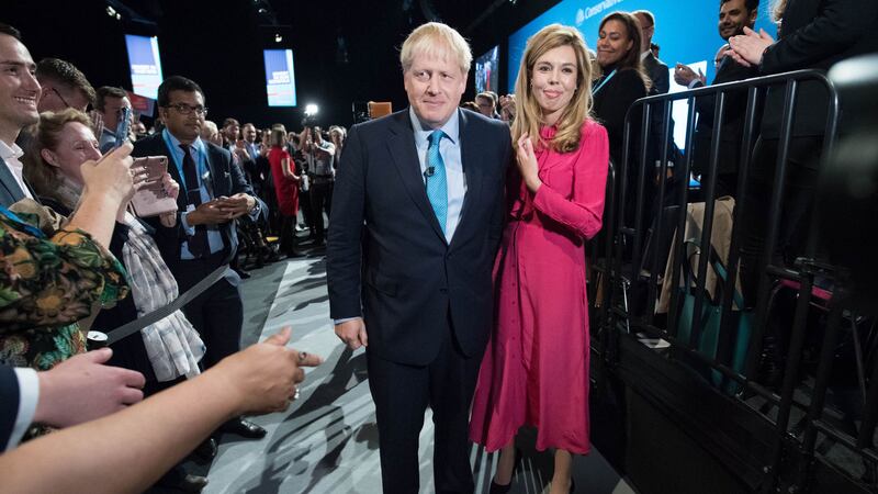 Boris Johnson leaves the stage with his partner Carrie Symonds after delivering his speech during the Conservative Party Conference at the Manchester Convention Centre. Picture by PA Wire&nbsp;