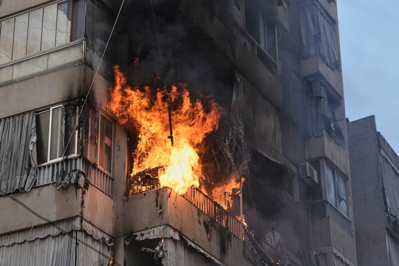 Smoke and flame rise from a residential building after an Israeli airstrike in central Beirut on Wednesday (Bilal Hussein/AP)