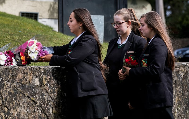 Students from Holy Trinity College leave floral tributes outside The Greenvale Hotel in Cookstown, Co Tyrone. Picture by Liam McBurney, Press Association&nbsp;