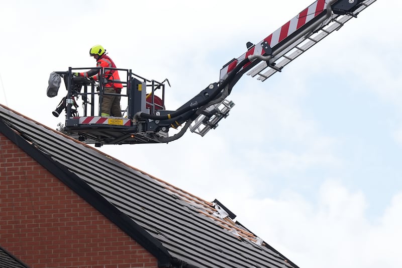 Firefighters have been making homes safe after strong winds sent tiles and chimney pots flying