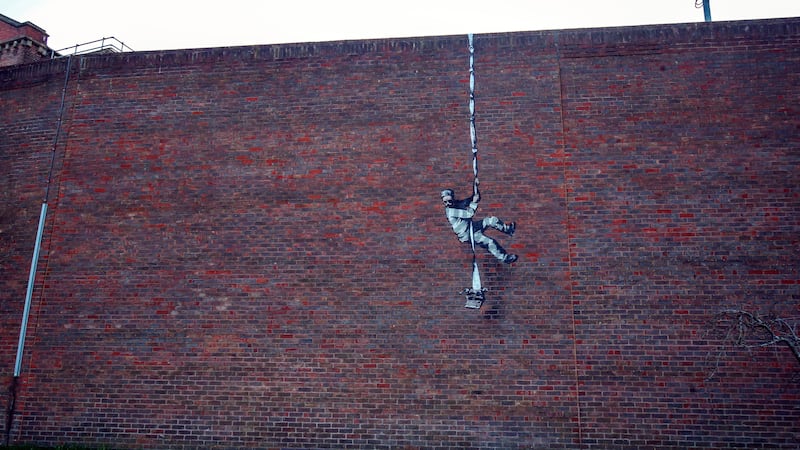 The artwork, on the red brick wall of the former Reading Prison, shows an inmate escaping lockdown.
