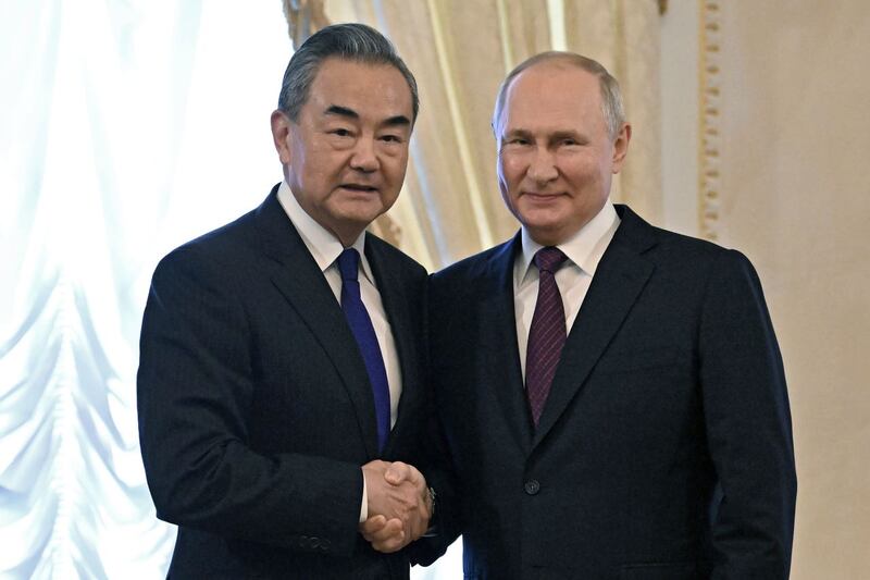 Vladimir Putin with Chinese foreign minister Wang Yi