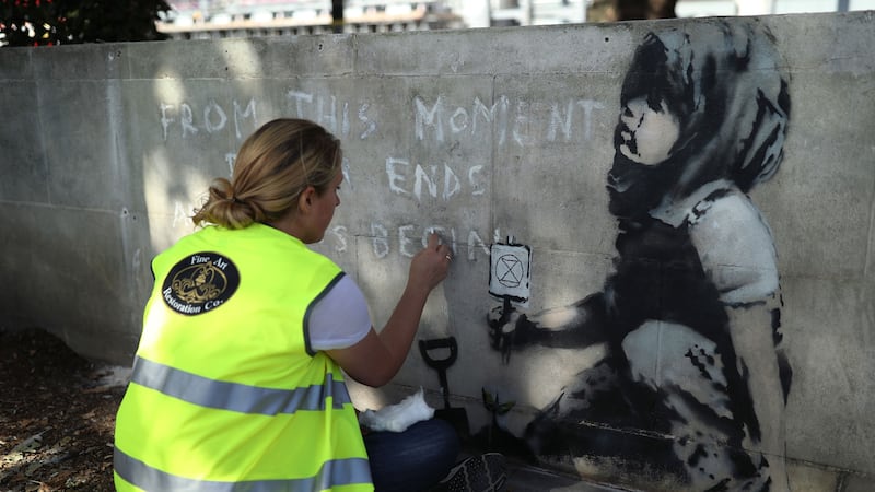 The famed graffiti artist’s work appeared in Westminster after demonstrations by Extinction Rebellion.