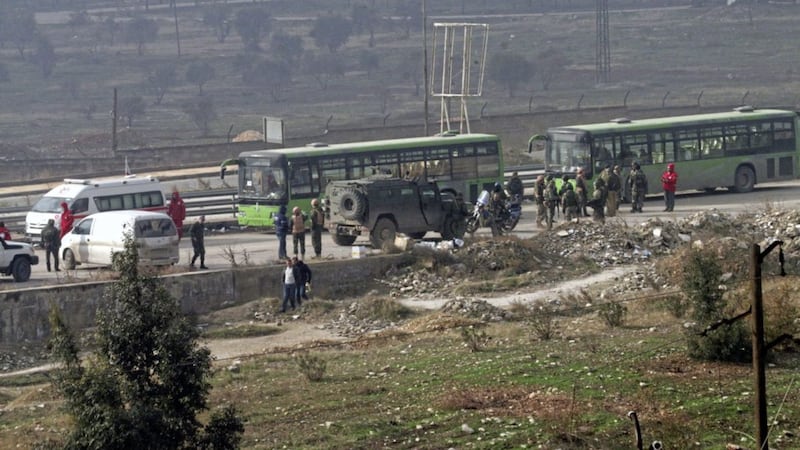Green government buses carry residents evacuating from eastern Aleppo Picture by SANA via AP 