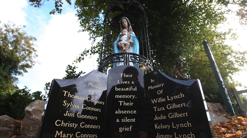 A memorial headstone at the Traveller site Carrickmines in south Dublin where a fire killed five adults and five children a year ago Picture: Brian Lawless/PA 
