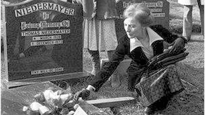 Ingeborg Niedermayer at the grave of her husband, German businessman Thomas Niedermayer 