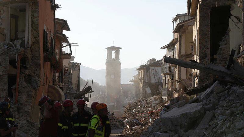 Firefighters work along the main street in Amatrice, central Italy, on Saturday. Picture by Antonio Calanni, Associated Press 
