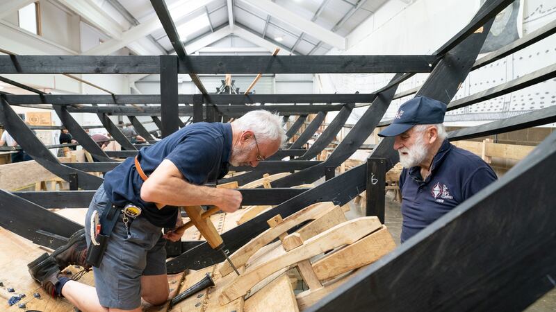 David Steptoe works on the replica of the Sutton Hoo longship, at the Longshed in Woodbridge, Suffolk (Joe Giddens/PA)