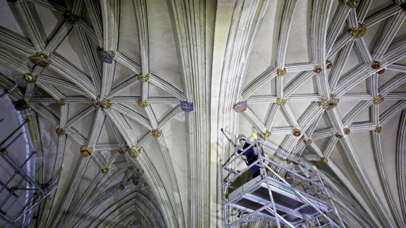 DO NOT BE AFRAID - EVEN OF HEIGHTS...: A member of the Canterbury Archaeological Trust uses a backpack vacuum cleaner in a rare cleaning operation to remove decades of accumulated dust and grime from the roof of the Nave in Canterbury Cathedral, Kent. Picture by Gareth Fuller/PA Wire 