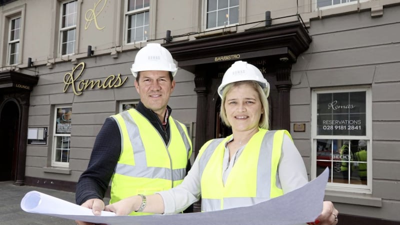 Andrew Gedge, managing director of Wolf Inns, and Leanne McClinton, manager of Romas, survey plans for the &pound;500,000 refurbishment of the Newtownards venue. Photo: Darren Kidd/PressEye 