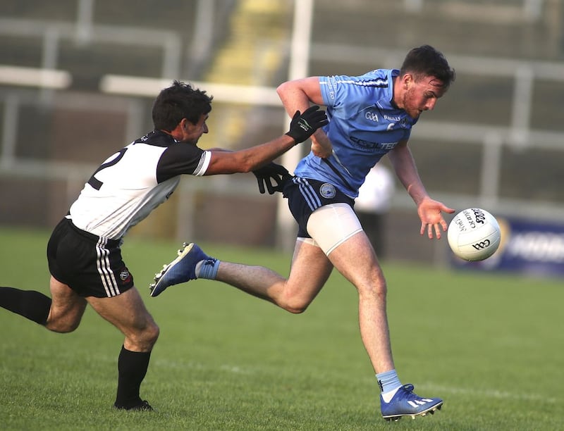 &nbsp;Mayobridge's Kevin McClorey comes away with the ball despite the close attention of Kilcoo's Niall Branagan  during the Down SFC clash at Pairc Esler, Newry last night, Friday August 14 2020. Picture by Hugh Russell