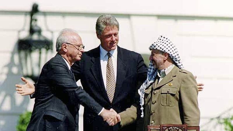 Bill Clinton presides over a handshake sealing the Oslo accords between Israeli prime minister Yitzhak Rabin and PLO leader Yasser Arafat at the White House in 1993 